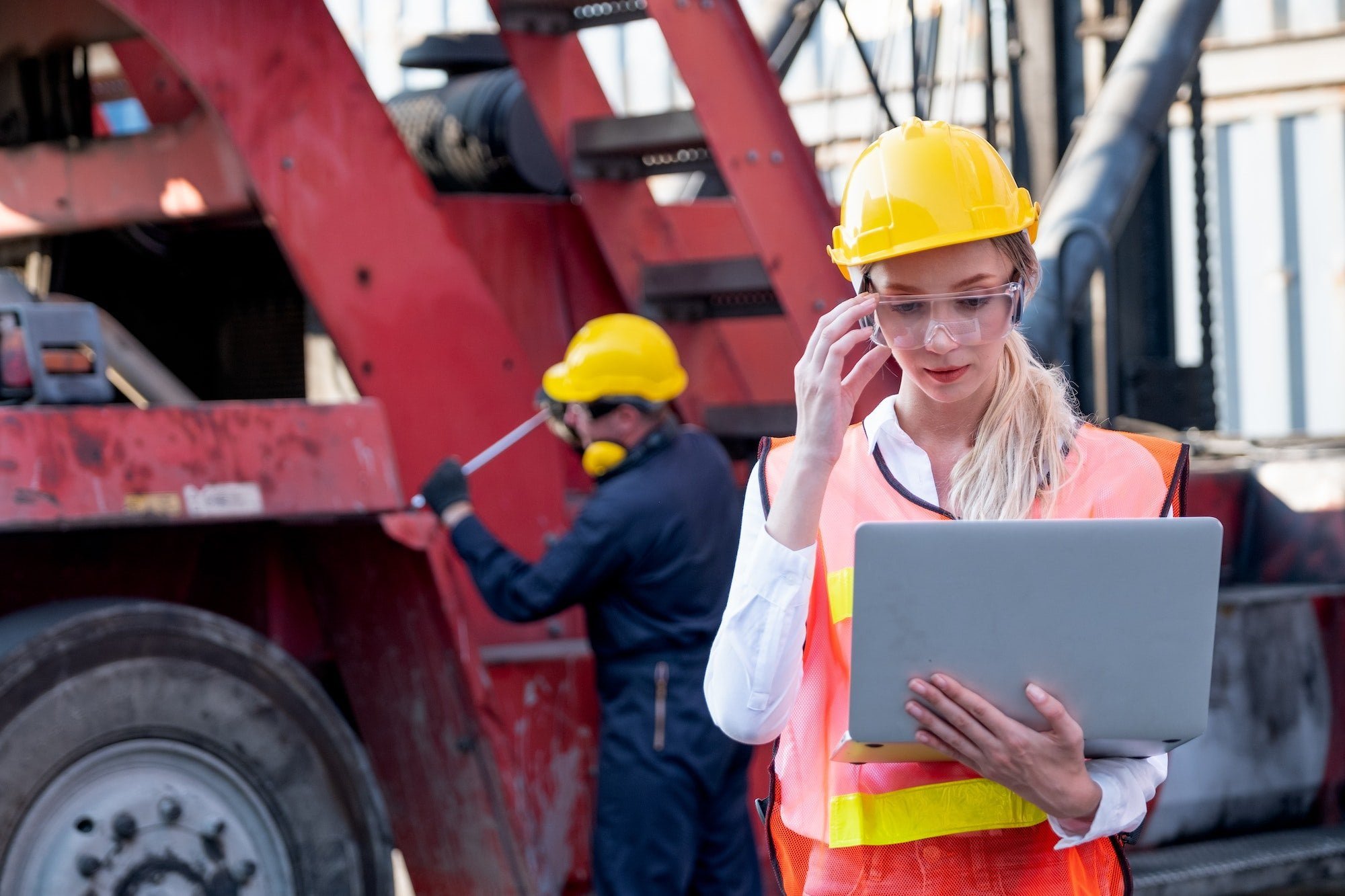 5 Advantages of eLearning for Safety and Health training 6 Pretty foreman woman or worker stand with touch her safety eye glasses and holding laptop