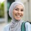 Close-up portrait of Muslim female student in hijab, woman with backpack behind her back smiling Close-up portrait of Muslim female student in hijab, woman with backpack behind her back smiling